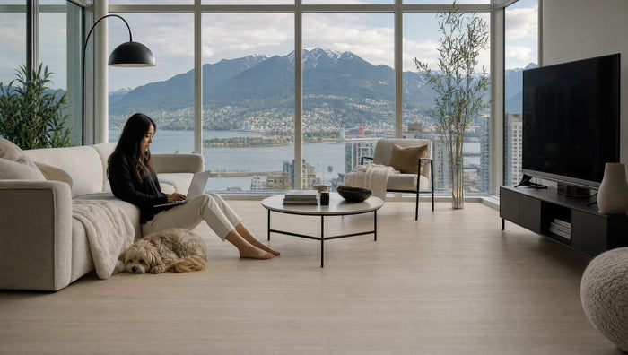 Working from the floor of a downtown Vancouver condo with Mossy Stone laminate and a North Shore view