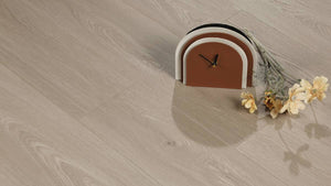 White Peaks AC5 laminate plank angle view showing 4-sided painted bevel and bright grain texture