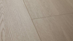 Mossy Stone AC5 laminate plank angle view showing 4-sided painted bevel and grey grain texture